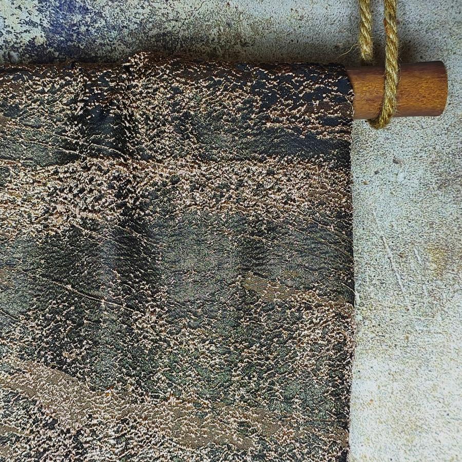 Colored heavy-duty designer fabric with golden thread luster and solid particles