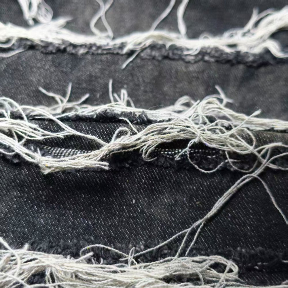 Black washed tie-dye denim fabric with horizontal stripes and fringed edges