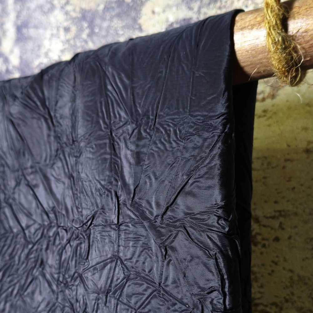 Black irregularly pleated texture embossed fabric
