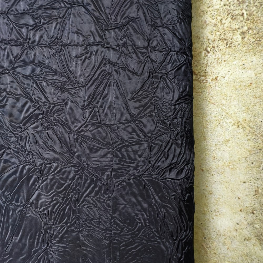 Black irregularly pleated texture embossed fabric